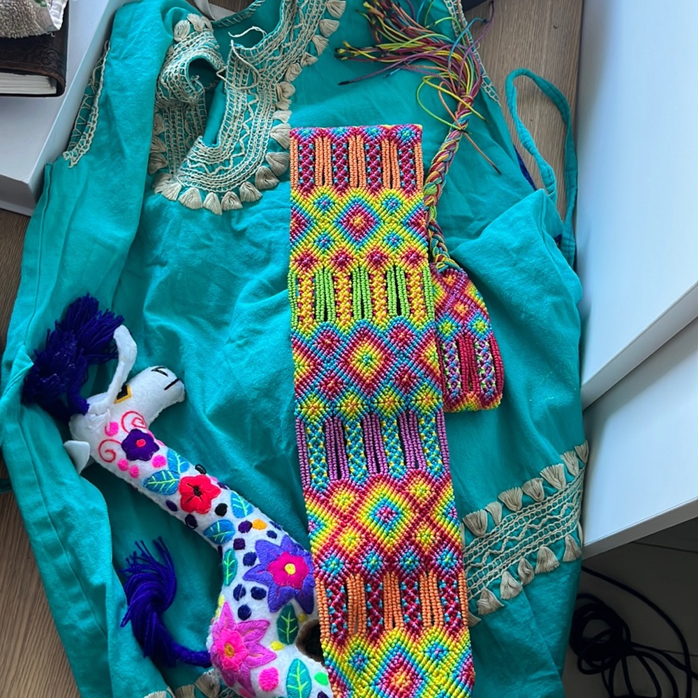 Assorted Mexican reliquaries. A blouse, stuffed animal and a belt